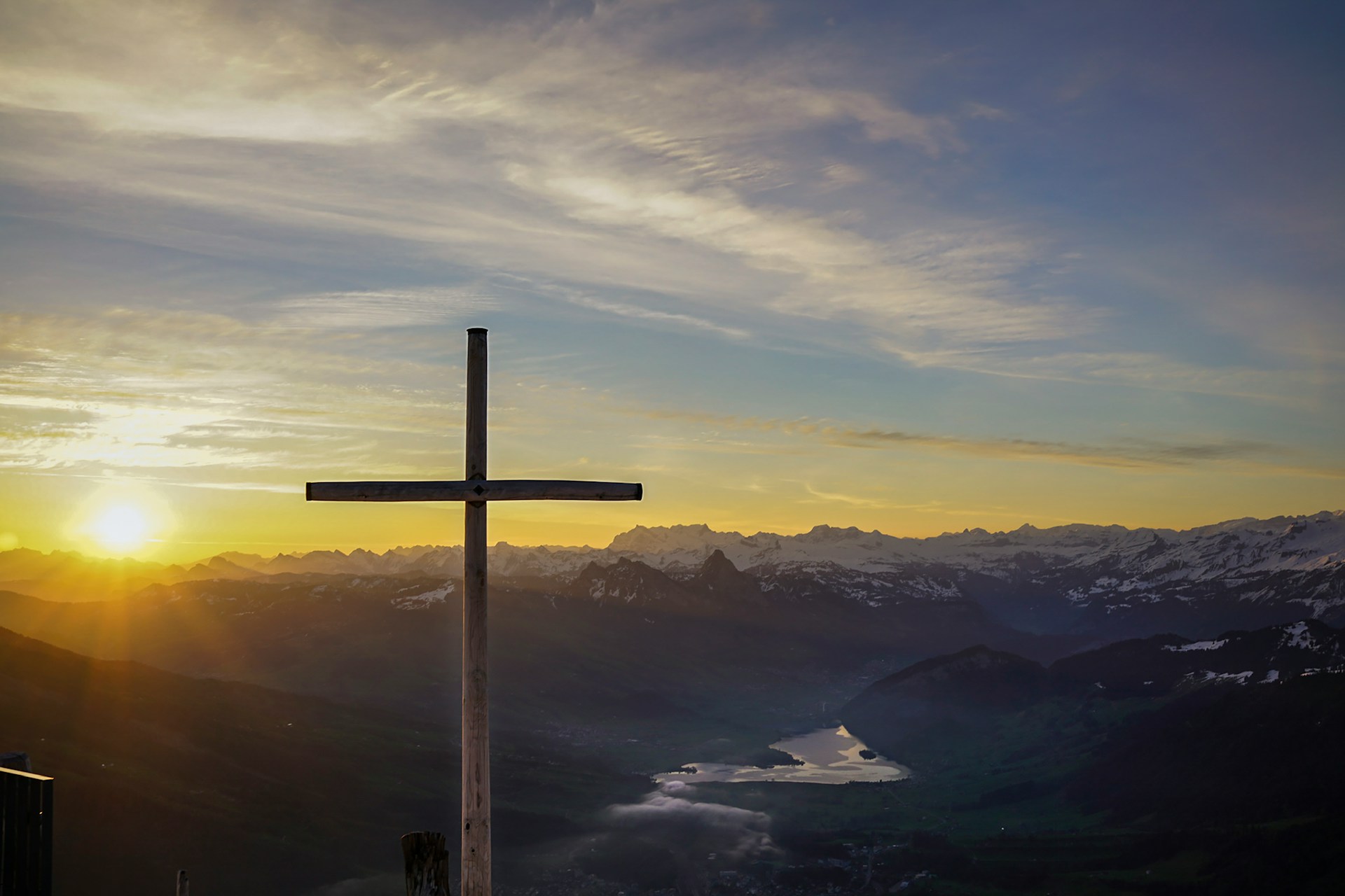 Cross on a mountain at sunrise.
